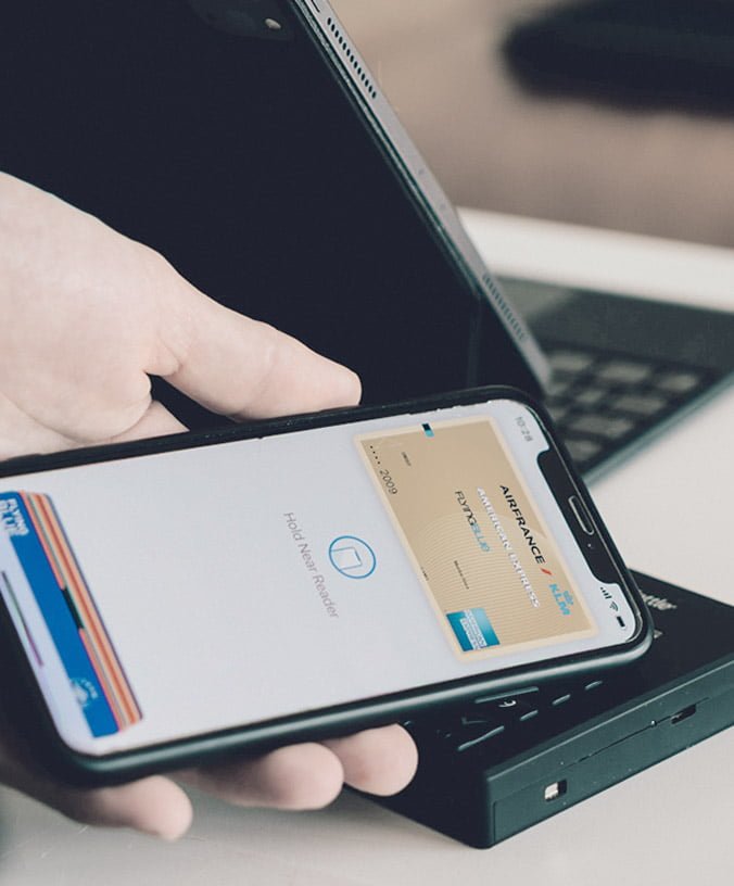 Patient paying for treatment with a phone at a card terminal