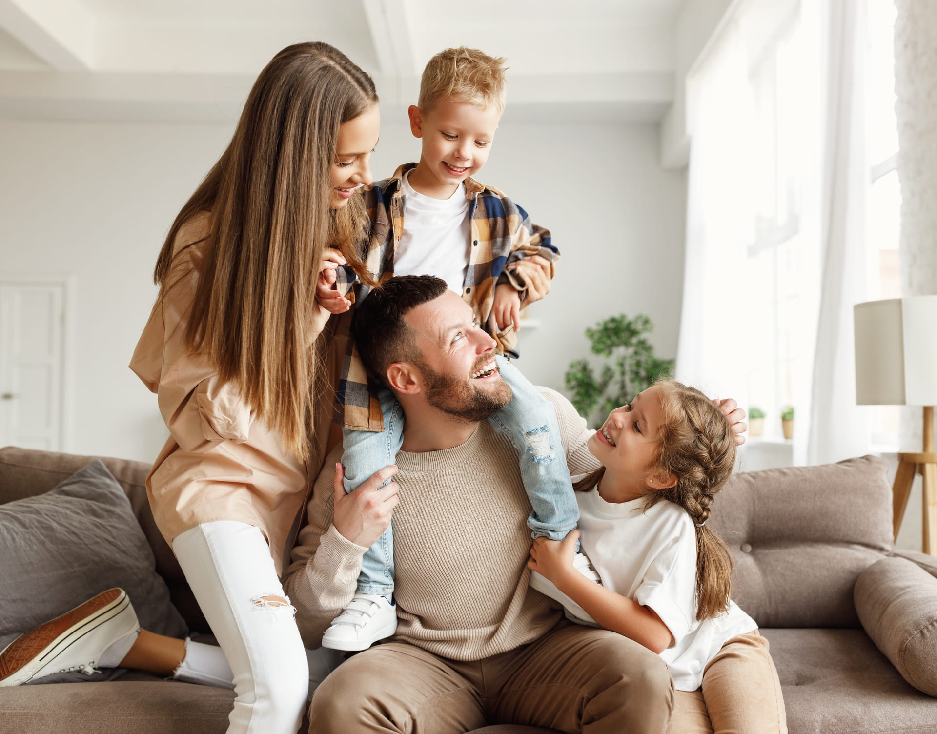 Parents and two young children playing together at home