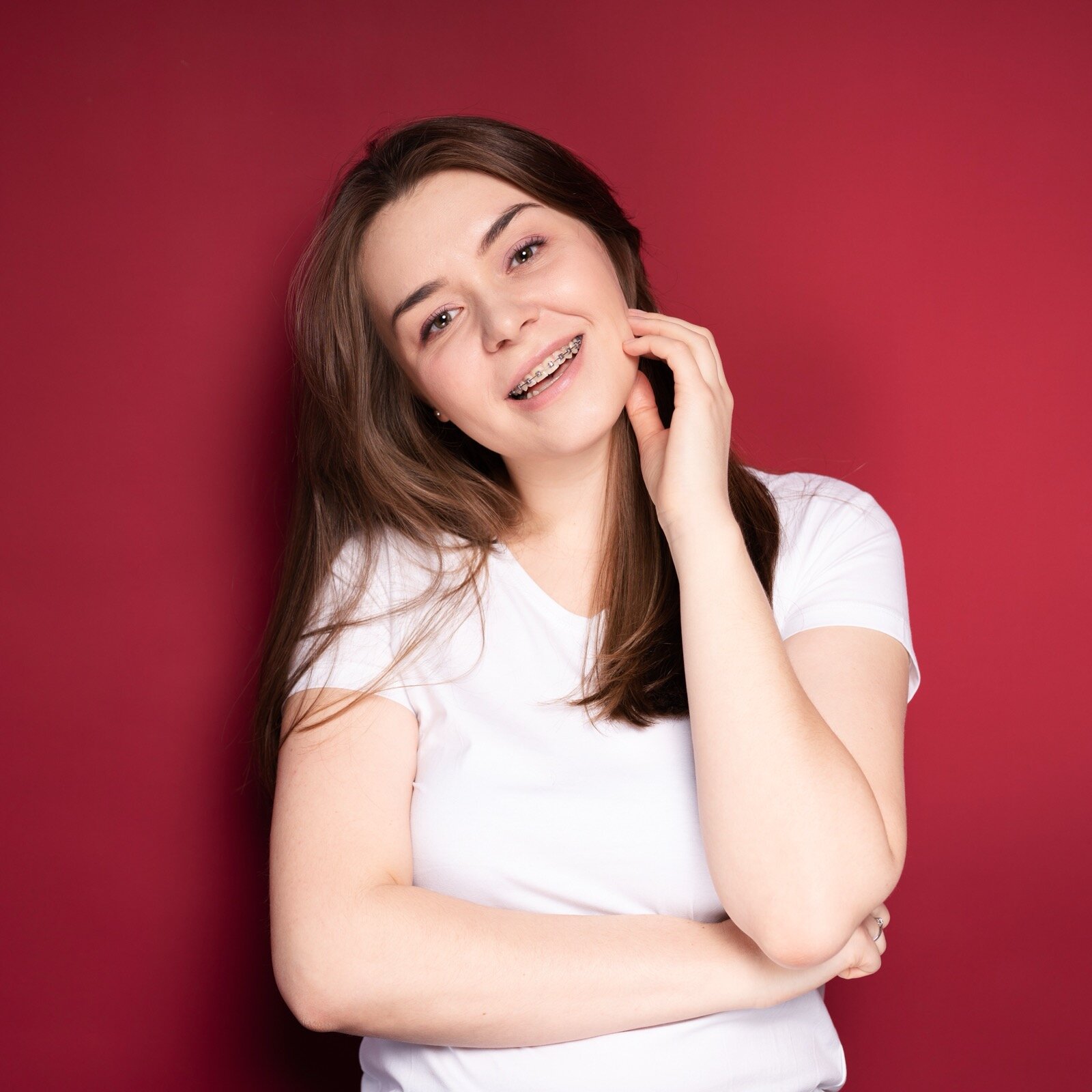 Smiling teenage girl with traditional metal braces