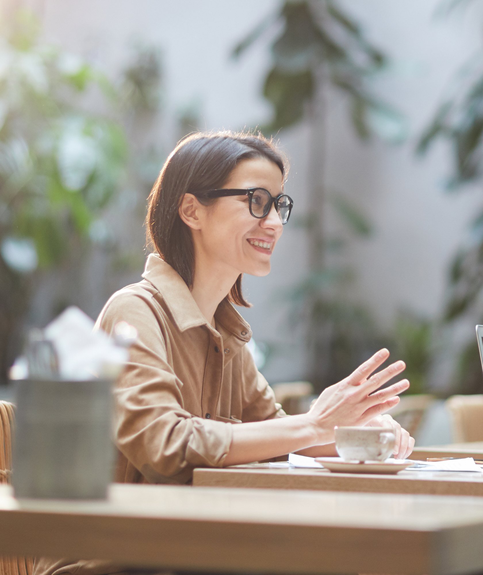 Patient talking with a care coordinator over paperwork at a table Patient talking with a care coordinator over paperwork at a table
